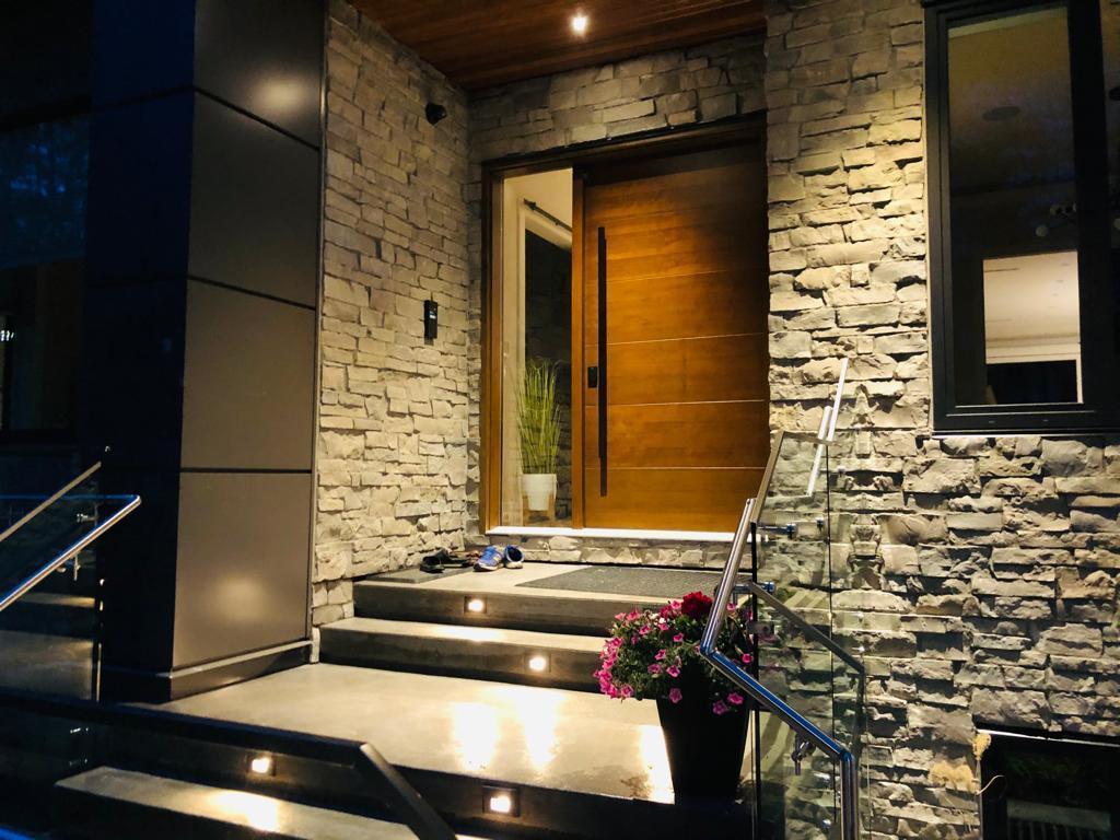 Detailed stone and wood entry built by Aim Baaaz Builders
